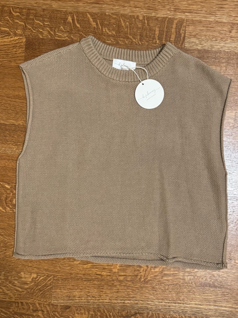 Sleeveless sweater in taupe. NWT. Size large.